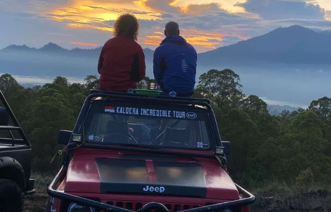 Couple on jeep rooftop watching Bali sunrise